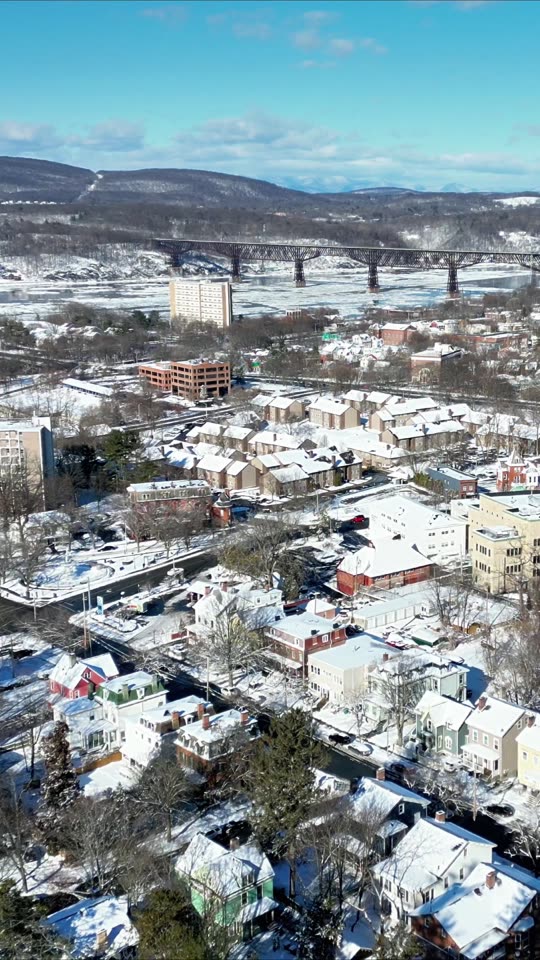 Descending over downtown Poughkeepsie in winter (vert)