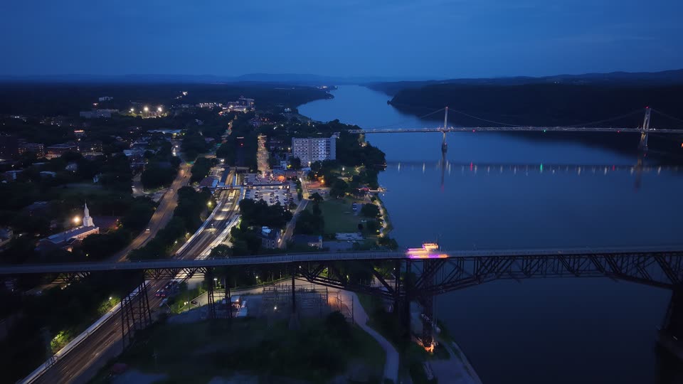 Flying downriver near the Walkway in Poughkeepsie at night towards the waterfront