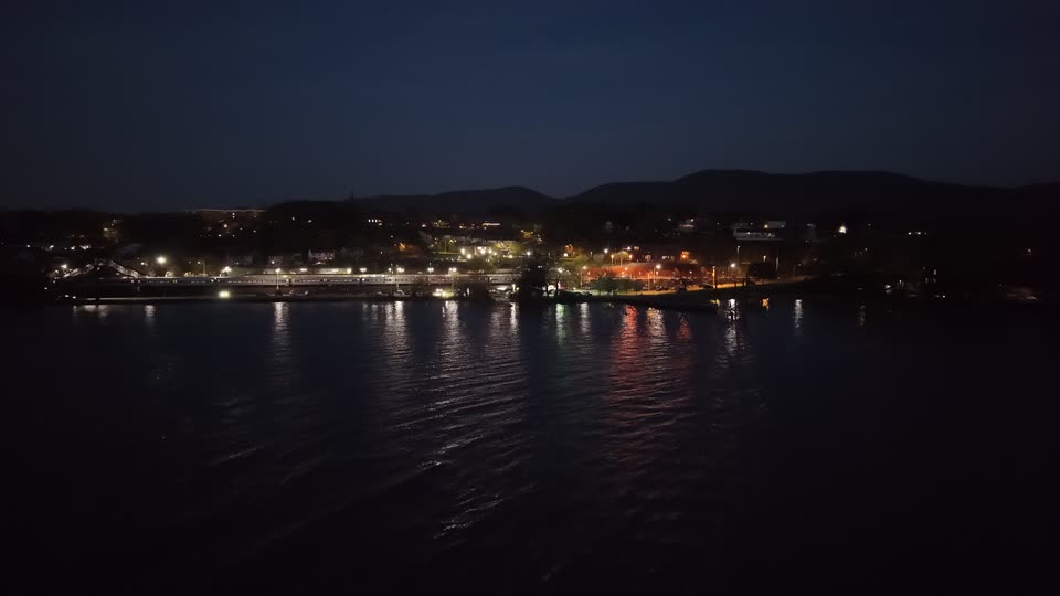 Flying towards Beacon train station as a train leaves at night