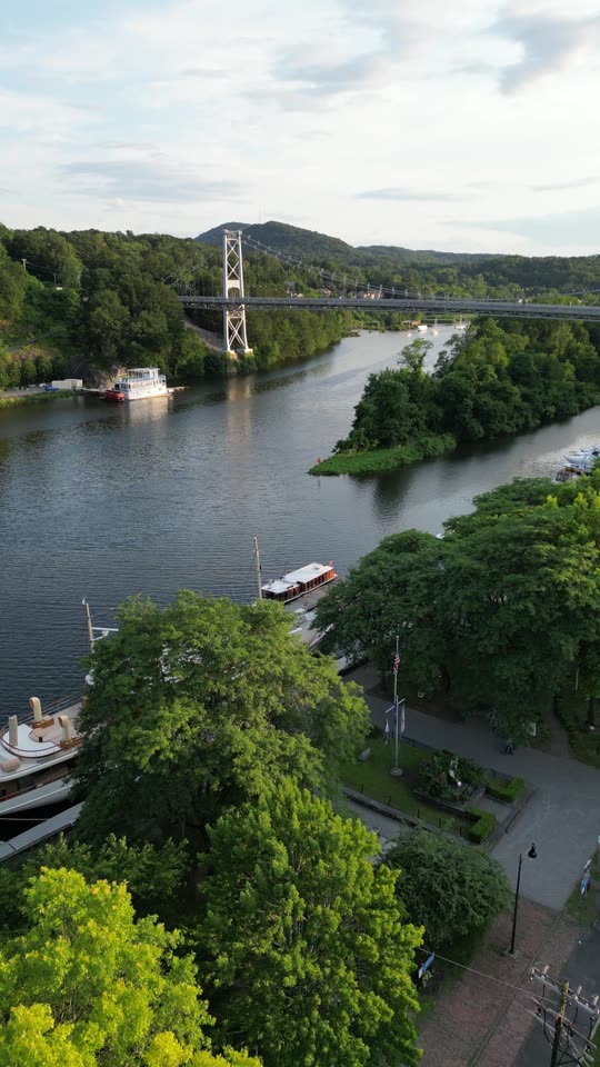 Pan down towards boat in the Rondout (vert)
