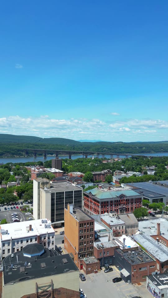 Rising over downtown Poughkeepsie looking towards the bridges (vert)