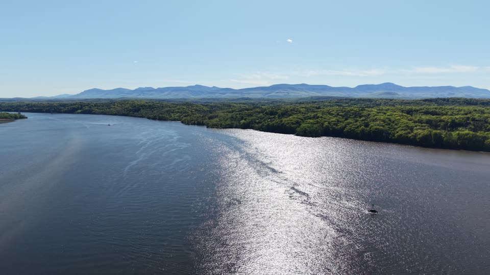 Turning descent towards water looking towards Catskills near Hudson