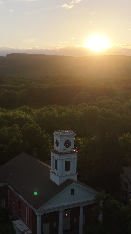 Zoomed orbit of church steeple on Huguenot Street at evening